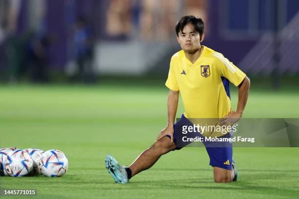 Takefusa Kubo of Japan stretches during the Japan Training Session at Al Sadd SC New Training Facilities on November 30, 2022 in Doha, Qatar.