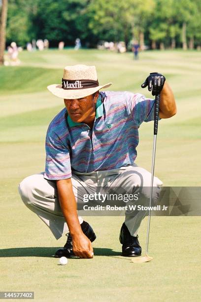 Japanese golfer Isao Aoki lines up a shot during the PGA Seniors' Championship at the PGA National Golf Club, Palm Beach Gardens, Florida, 1996.