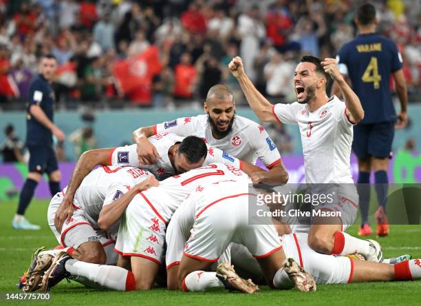 Wahbi Khazri of Tunisia celebrates with teammates after scoring their team's first goal during the FIFA World Cup Qatar 2022 Group D match between...