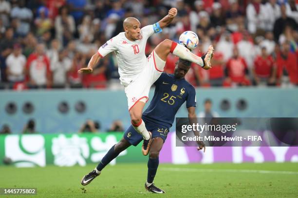 Wahbi Khazri of Tunisia battles for possession with Eduardo Camavinga of France during the FIFA World Cup Qatar 2022 Group D match between Tunisia...