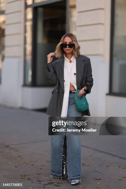 Karin Teigl is seen wearing Balenciaga white button shirt, Miu Miu Hobo turquoise bag, H&M striped grey oversized blazer, Dior black leather gold...