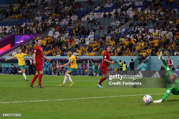 Mathew Leckie of Australia looks over his shoulder as the ball passes Kasper Schmeichel of Denmark to give the side a 1-0 lead during the FIFA World...