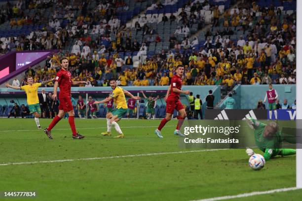 Mathew Leckie of Australia looks over his shoulder as the ball passes Kasper Schmeichel of Denmark to give the side a 1-0 lead during the FIFA World...