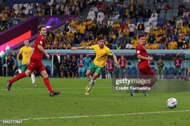Mathew Leckie of Australia fires the ball past Kasper Schmeichel of Denmark to give the side a 1-0 lead during the FIFA World Cup Qatar 2022 Group D...