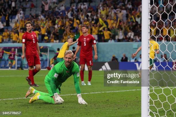 Kasper Schmeichel, Joachim Andersen and Joakim Maehle of Denmark react as Mathew Leckie of Australia celebrates with team mate Riley McGree after...