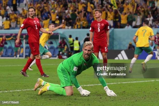 Kasper Schmeichel, Joachim Andersen and Joakim Maehle of Denmark react as Mathew Leckie of Australia celebrates with team mate Riley McGree after...