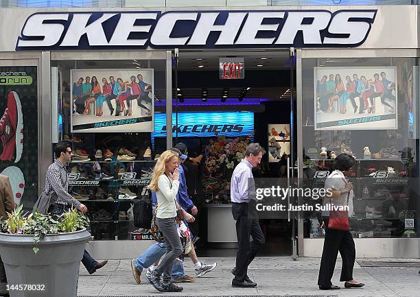 Pedestrians walk by a Skechers store on May 16, 2012 in New York City. The Federal Trade Commission announced that Skechers has agreed to pay $40...