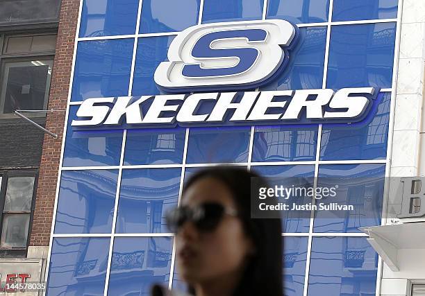 Pedestrian walks by a Skechers store on May 16, 2012 in New York City. The Federal Trade Commission announced that Skechers has agreed to pay $40...