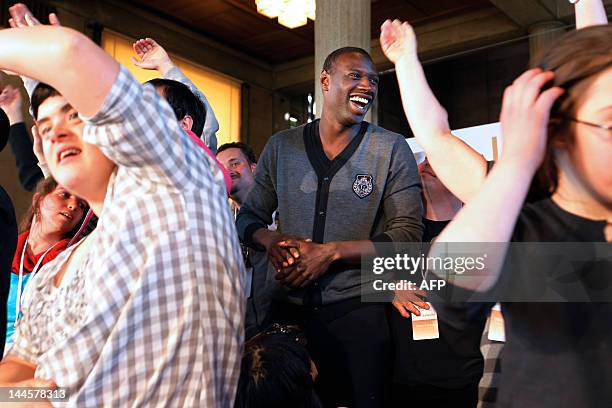 French actor of the French movie "Intouchables" Omar Sy gives dance lessons to disabled persons on May 16, 2012 at the Economic, Social and...