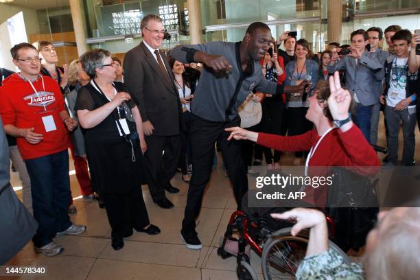 French actor of the French movie "Intouchables" Omar Sy gives dance lessons to disabled persons on May 16, 2012 at the Economic, Social and...