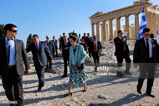 Princess Anne, Princess Royal walks atop the Acropolis surrounded by security officers as she attends an Olympic Flame ceremony on May 16, 2012 in...