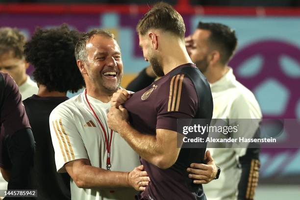 Hansi Flick, Head Coach of Germany, and Niclas Füllkrug of Germany react during the Germany Training Session at Al Shamal Stadium on November 30,...