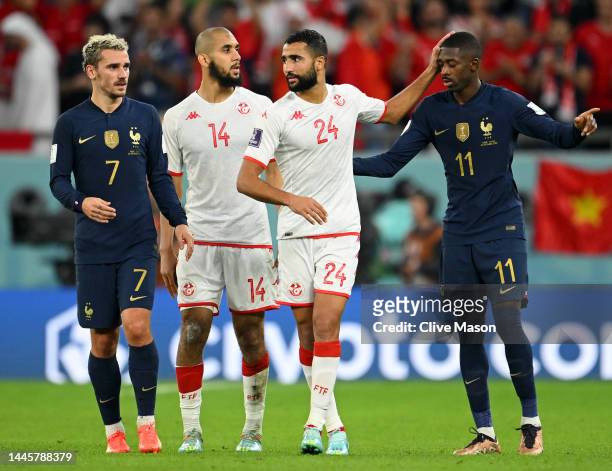 Antoine Griezmann and Ousmane Dembele of France embrace Aissa Laidouni and Ali Abdi of Tunisia after the FIFA World Cup Qatar 2022 Group D match...