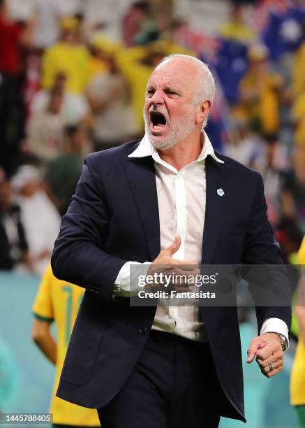 Graham Arnold Head coach of Australia celebrates the 1-0 victory and the team's passage to the knockout stages following the final whistle of the...