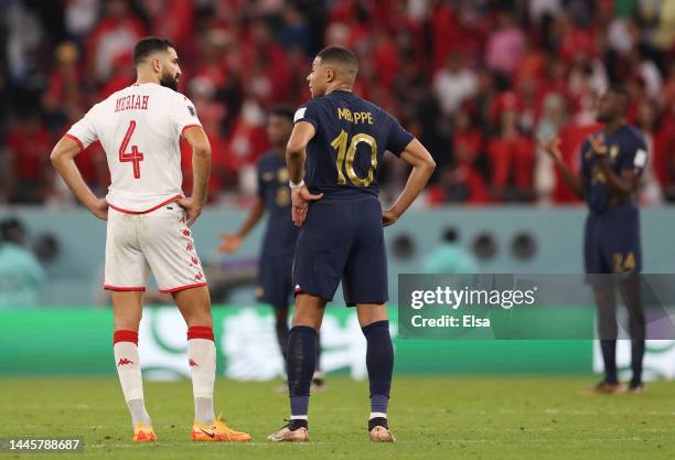 Yassine Meriah of Tunisia speaks with Kylian Mbappe of France during the FIFA World Cup Qatar 2022 Group D match between Tunisia and France at...