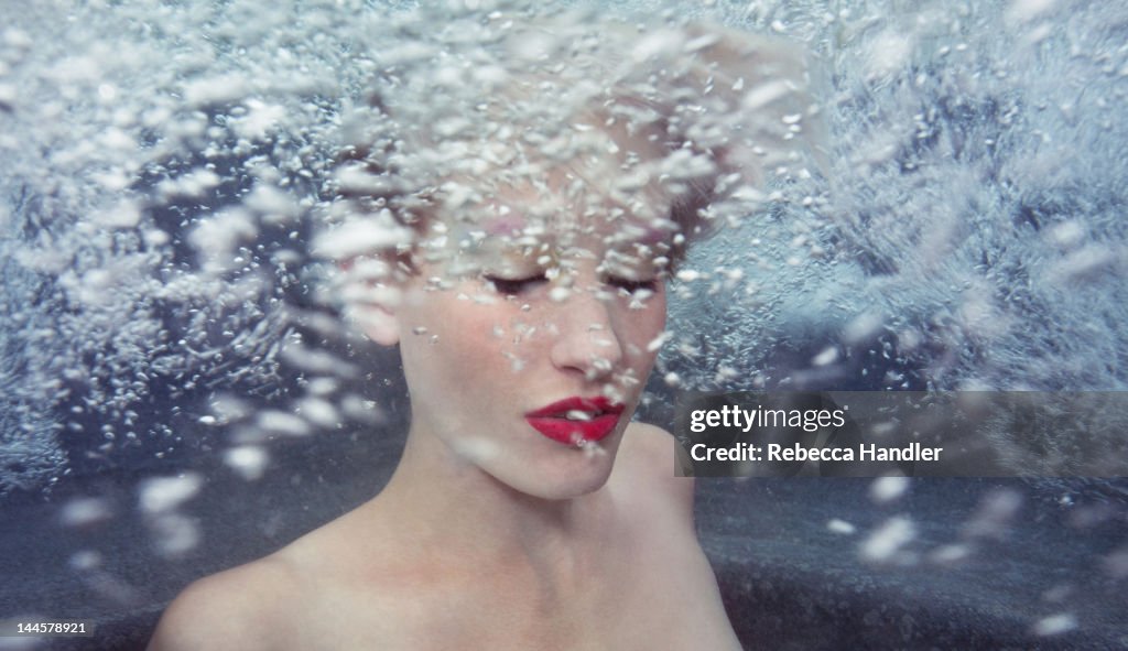 Young Woman Underwater with bubbles