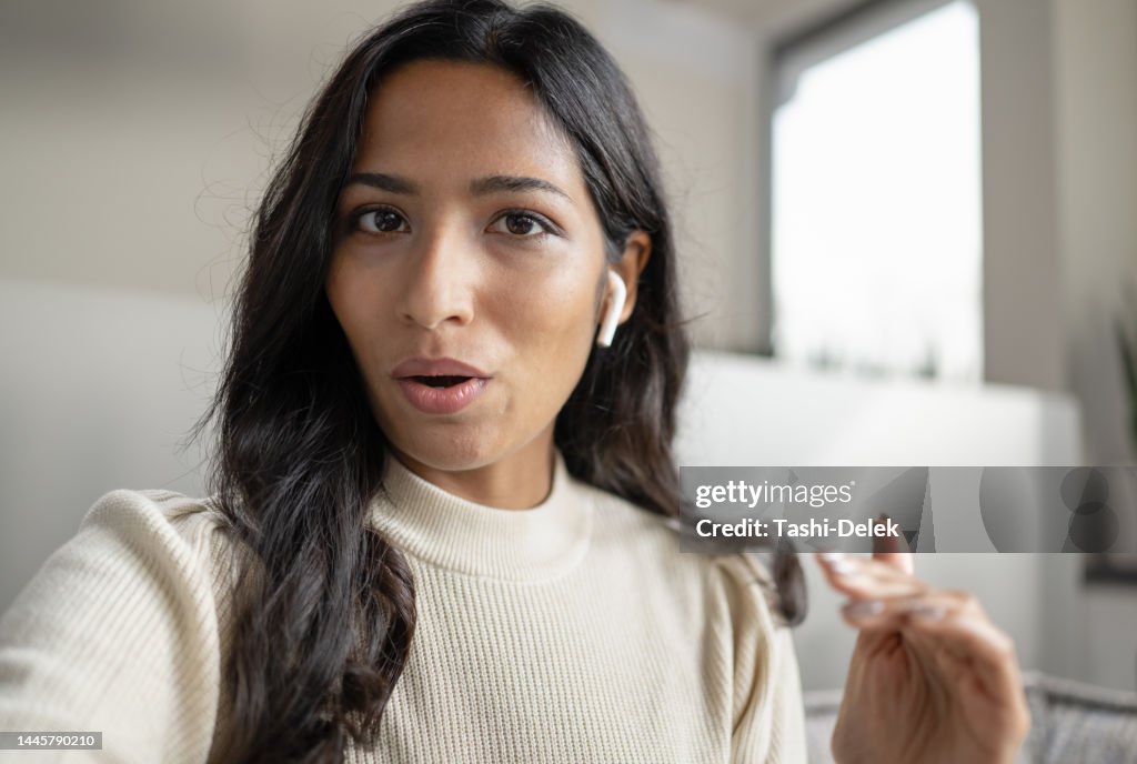 Female Influencer Vlogging Online With Smartphone From Home