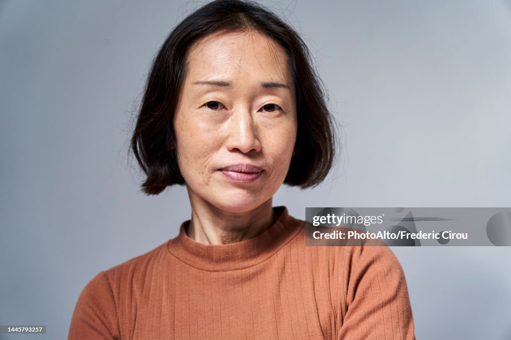 Serious mature Asian woman looking at the camera