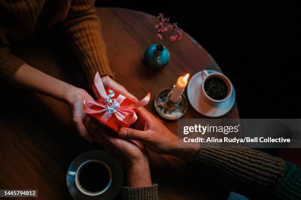 couple exchanging gifts - exchanging gifts stock pictures, royalty-free photos & images