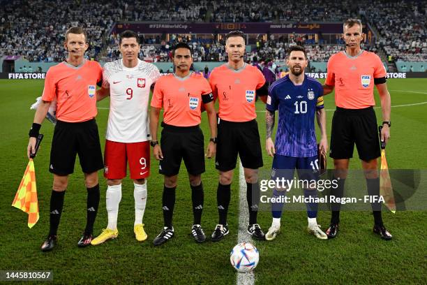 Robert Lewandowski of Poland, Referee Danny Makkelie and Lionel Messi of Argentina pose for a photo prior to the FIFA World Cup Qatar 2022 Group C...