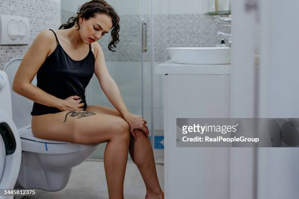 those cramps are killing me - woman hemorrhoids stock pictures, royalty-free photos & images