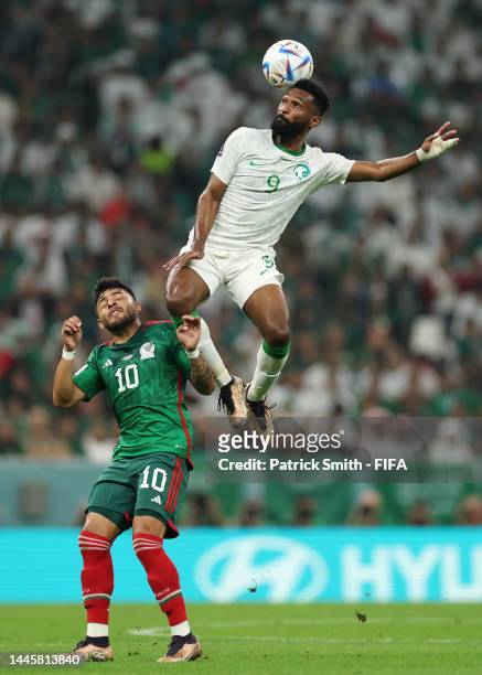 Feras Albrikan of Saudi Arabia and Alexis Vega of Mexico compete for the ball during the FIFA World Cup Qatar 2022 Group C match between Saudi Arabia...