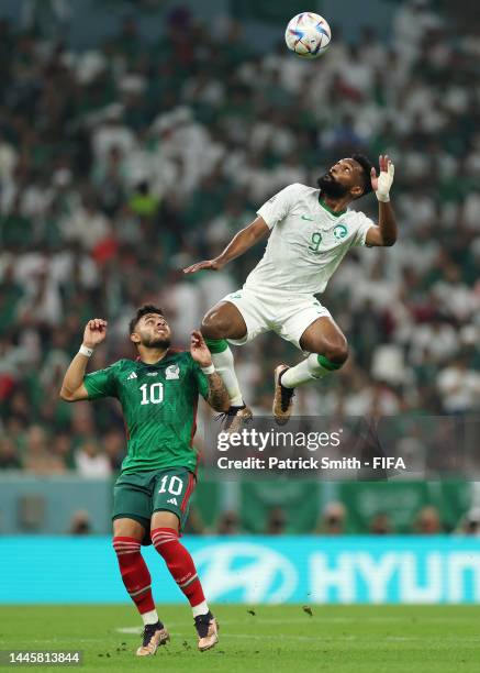 Feras Albrikan of Saudi Arabia and Alexis Vega of Mexico compete for the ball during the FIFA World Cup Qatar 2022 Group C match between Saudi Arabia...