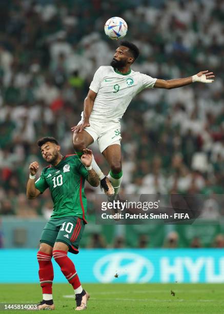 Feras Albrikan of Saudi Arabia and Alexis Vega of Mexico compete for the ball during the FIFA World Cup Qatar 2022 Group C match between Saudi Arabia...