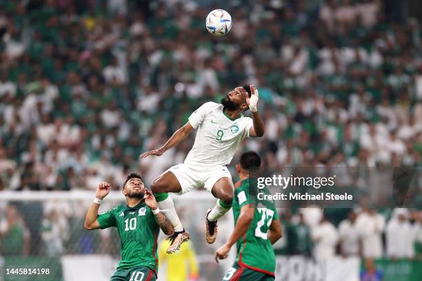 Feras Albrikan of Saudi Arabia jumps for the ball with Alexis Vega of Mexico during the FIFA World Cup Qatar 2022 Group C match between Saudi Arabia...