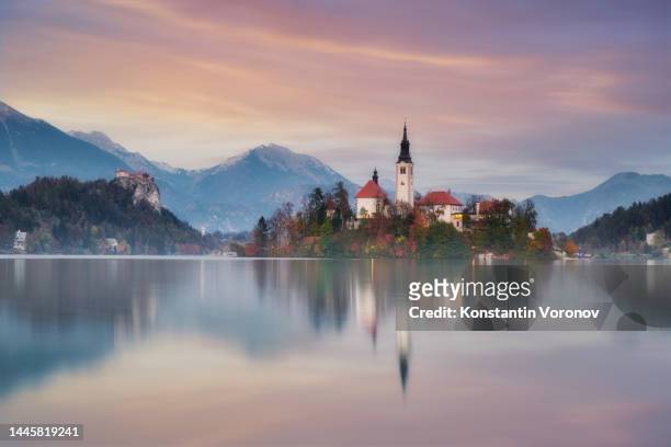 lake bled in slovenia at the evening. famous slovenian landmark. - lubiana stock pictures, royalty-free photos & images