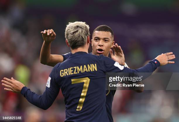 Antoine Griezmann of France celebrates with Kylian Mbappe after scoring a goal that was ruled offside after a Video Assistant Referee review during...