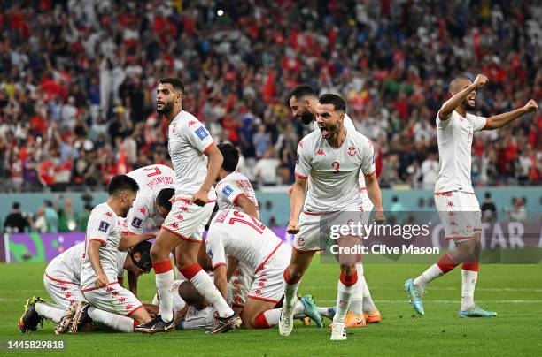 Wahbi Khazri of Tunisia celebrates with teammates after scoring their team's first goal during the FIFA World Cup Qatar 2022 Group D match between...