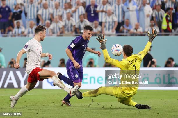 Nicolas Tagliafico of Argentina attempts to chip Wojciech Szczesny of Poland during the FIFA World Cup Qatar 2022 Group C match between Poland and...