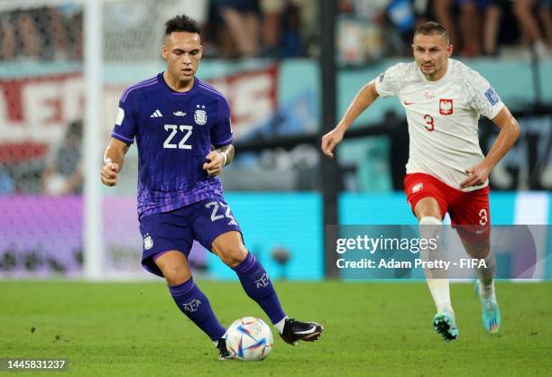 Lautaro Martinez of Argentina is challenged by Artur Jedrzejczyk of Poland during the FIFA World Cup Qatar 2022 Group C match between Poland and...