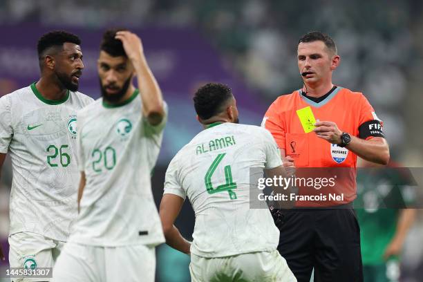 Abdulelah Al-Amri of Saudi Arabia is shown a yellow card by referee Michael Oliver during the FIFA World Cup Qatar 2022 Group C match between Saudi...