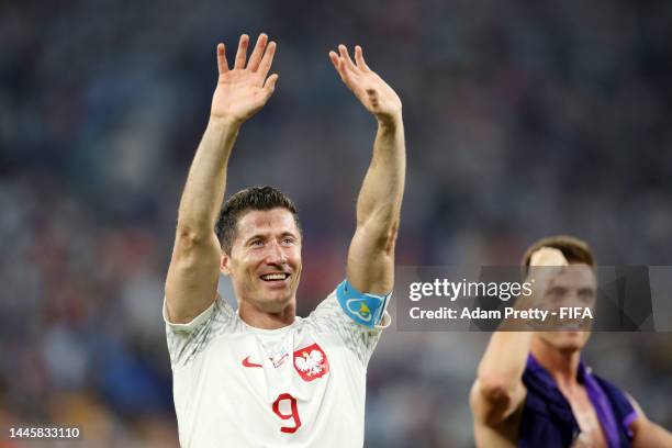 Robert Lewandowski of Poland acknowledges the fans as they celebrate after their sides qualification to the knockout stages during the FIFA World Cup...