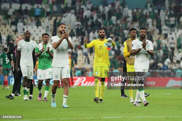 Saudi Arabia players salute the fans following the final whistle of the FIFA World Cup Qatar 2022 Group C match between Saudi Arabia and Mexico at...