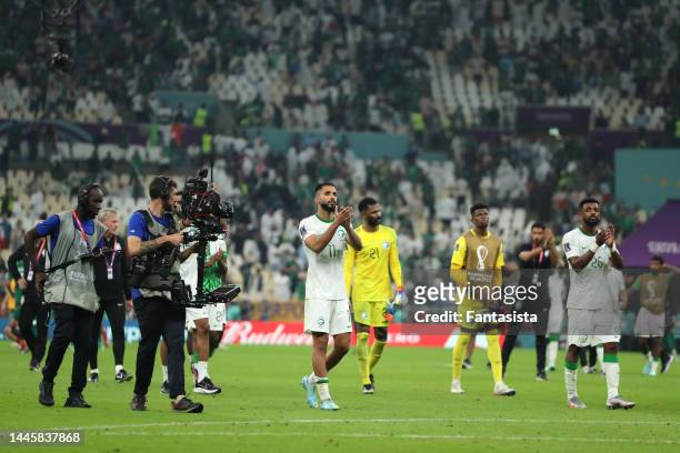 Saudi Arabia players salute the fans following the final whistle of the FIFA World Cup Qatar 2022 Group C match between Saudi Arabia and Mexico at...