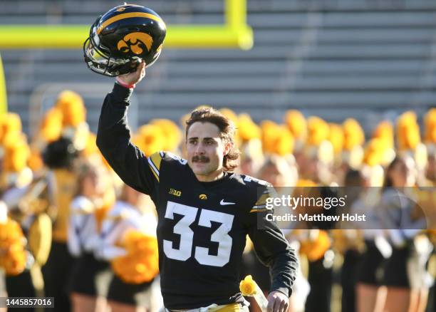 Defensive back Riley Moss of the Iowa Hawkeyes runs out as part of the Senior Day festivities before the match-up against the Nebraska Cornhuskers at...