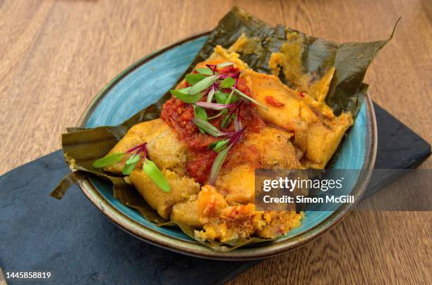 Tamal Con Harina De Arroz Y Quinoa Guiso Criollo Zanahoria Costilla De Res Y Pollo Campesino On A Slate Serving Platter, Stock-Foto