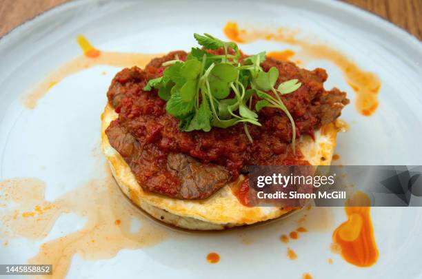 corn arepa with fried egg, roast beef and hogao (colombian tomato and onion sauce) - arepa top view stock pictures, royalty-free photos & images