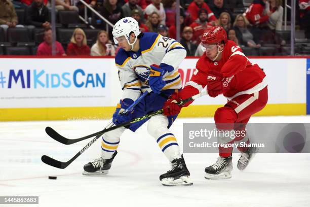 Dylan Cozens of the Buffalo Sabres gets past Lucas Raymond of the Detroit Red Wings to score a first period goal at Little Caesars Arena on November...