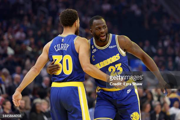 Draymond Green of the Golden State Warriors hugs Stephen Curry before their game against the San Antonio Spurs at Chase Center on November 14, 2022...