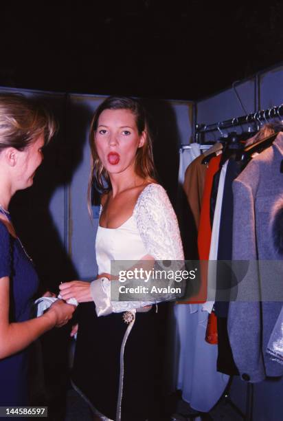 English model Kate Moss photographed backstage at fashion show in the early 1990's