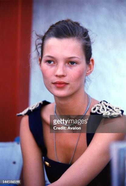 English model Kate Moss photographed backstage at fashion show in the early 1990's.