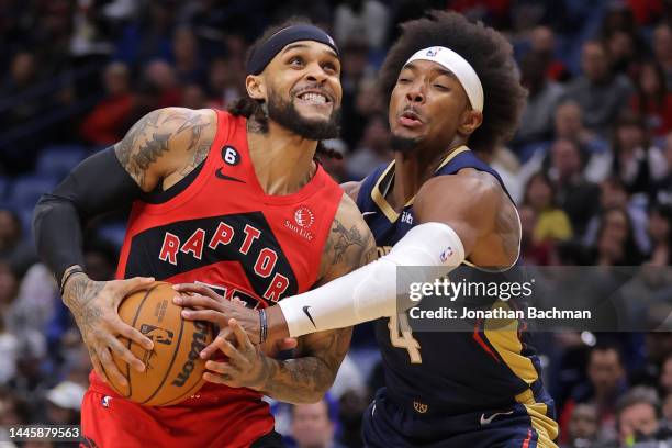 Gary Trent Jr. #33 of the Toronto Raptors drives against Devonte' Graham of the New Orleans Pelicans during the first half at Smoothie King Center on...