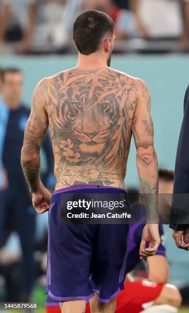 Leandro Paredes of Argentina shows his tiger tattoo on his back following the FIFA World Cup Qatar 2022 Group C match between Poland and Argentina at...