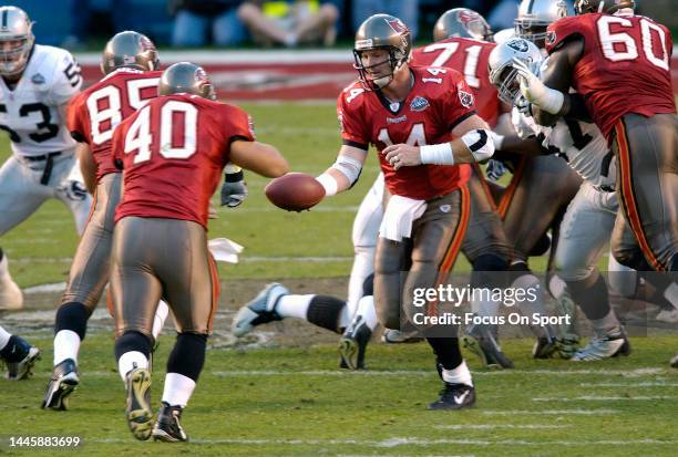 Brad Johnson of the Tampa Bay Buccaneers turns to handoff to Mike Alstott against the Oakland Raiders during Super Bowl XXXVII at Qualcomm Stadium on...