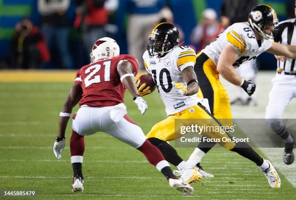 Santonio Holmes of the Pittsburgh Steelers cuts back on Antrel Rolle of the Arizona Cardinal in Super Bowl XLIII on February 1, 2009 at Raymond James...