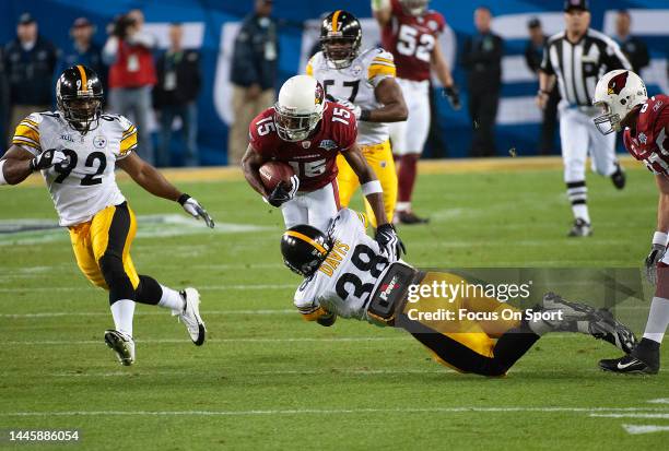 Steve Breaston of the Arizona Cardinal running with the ball gets tackled by Carey Davis of the Pittsburgh Steeler in Super Bowl XLIII on February 1,...